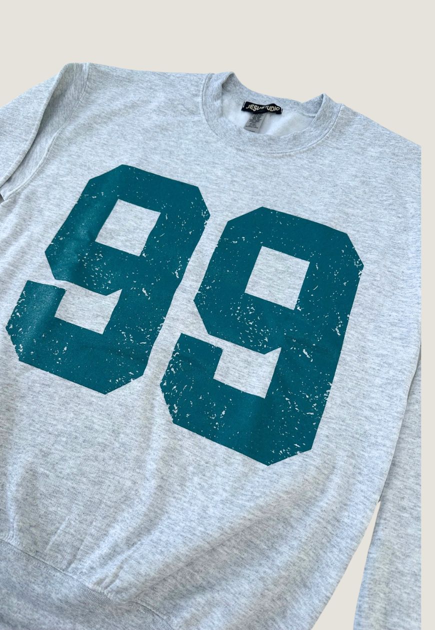 "THE 99" SWEATER